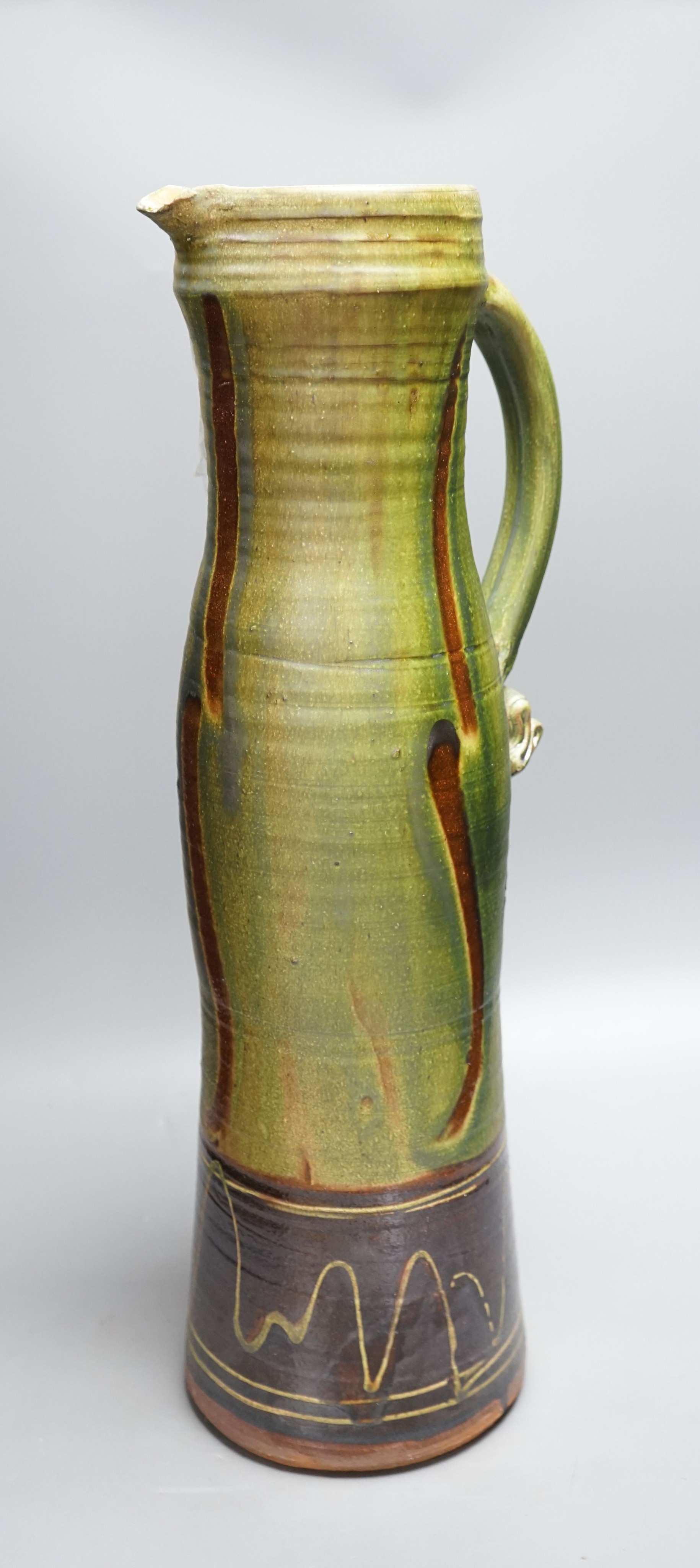 Clive Bowen (b.1943), a tall green glazed and brown slip decorated ewer, 59cm